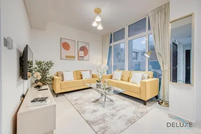 a living room with a couch and a table at Delightful 3BR Townhouse at DAMAC Hills 2 Dubailand by Deluxe Holiday Homes in Dubai