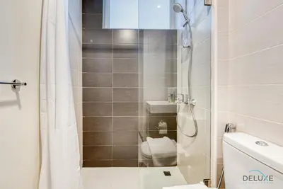a small bathroom with a shower and a toilet at Delightful 3BR Townhouse at DAMAC Hills 2 Dubailand by Deluxe Holiday Homes in Dubai