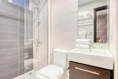 a white bathroom with a toilet and a sink at Opulent 3BR Townhouse at DAMAC Hills 2 Dubailand by Deluxe Holiday Homes in Dubai