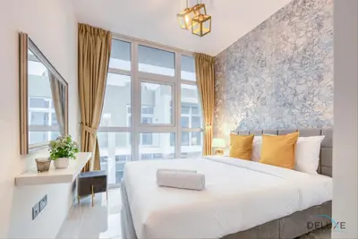 a bedroom with a large bed and a large window at Opulent 3BR Townhouse at DAMAC Hills 2 Dubailand by Deluxe Holiday Homes in Dubai