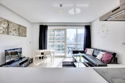 a living room with a couch and a table at 1 BD in West Avenue tower Dubai Marina in Dubai