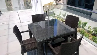 a glass table and chairs on a balcony at 1 BD in West Avenue tower Dubai Marina in Dubai