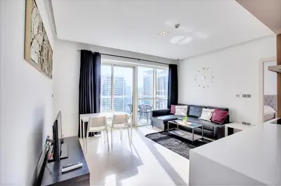 a living room with a couch and a table at 1 BD in West Avenue tower Dubai Marina in Dubai