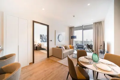 a living room with a dining table and a living room at Luton Vacation Homes - Marina View & Luxury 1BR - Jumeirah Living Marina Gate Tower 3 - 54AB49AB36AB in Dubai