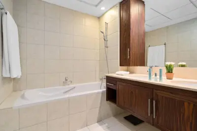 a bathroom with a bath tub and a sink at Spectacular Burj & Fountain View - Luxurious 3 Bedrooms & Maids room - The Residences in Dubai