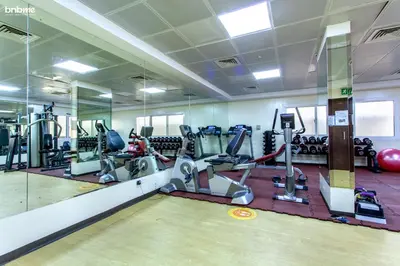 a gym with treadmills and elliptical machines at bnbmehomes - La Fontana in Dubai