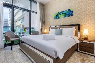 a bedroom with a large bed and a large window at bnbmehomes - Merano Tower in Dubai