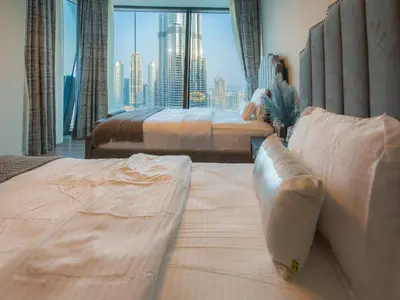 a hotel room with two beds and a large window at FIRST CLASS 3BR with full BURJ KHALIFA and FOUNTAIN VIEW in Dubai