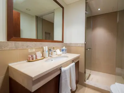 a bathroom with a sink and a shower at FIRST CLASS 3BR with full BURJ KHALIFA and FOUNTAIN VIEW in Dubai