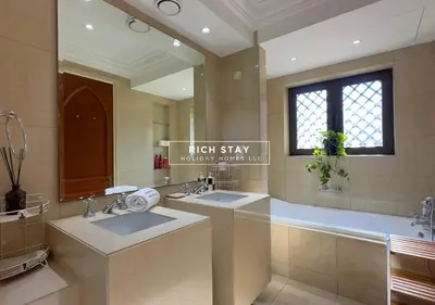 a large bathroom with two sinks and a tub at Spectacular 2BR in Souk Al Bahar, Downtown with Burj & Dubai Mall view by Rich Stay in Dubai