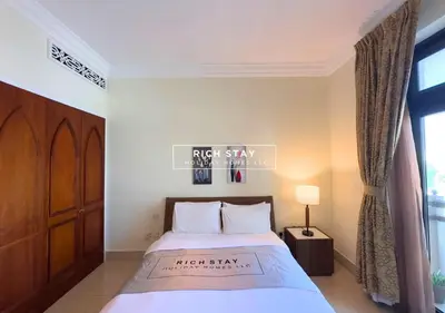 a bedroom with a bed and a window at Spectacular 2BR in Souk Al Bahar, Downtown with Burj & Dubai Mall view by Rich Stay in Dubai