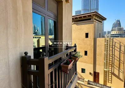 a balcony with potted plants and a view of the city at Spectacular 2BR in Souk Al Bahar, Downtown with Burj & Dubai Mall view by Rich Stay in Dubai