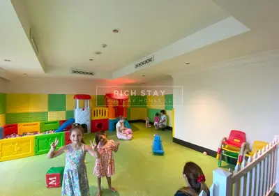 a group of children playing in a play room at Spectacular 2BR in Souk Al Bahar, Downtown with Burj & Dubai Mall view by Rich Stay in Dubai