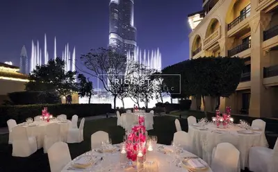 a banquet hall with white tables and white chairs at Spectacular 2BR in Souk Al Bahar, Downtown with Burj & Dubai Mall view by Rich Stay in Dubai