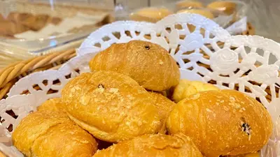 a basket full of breads sitting on a table at SITARA HOTEL APARTMENT in Dubai