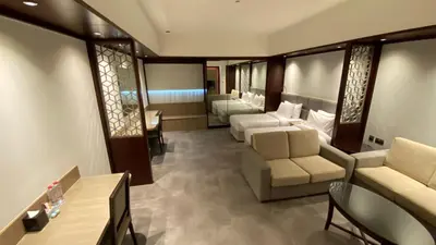 a living room with couches and chairs in a room at SITARA HOTEL APARTMENT in Dubai