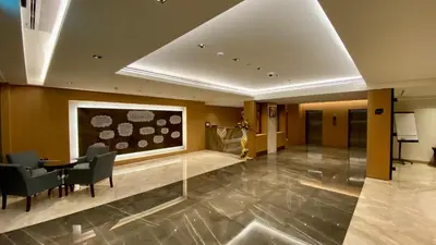 a lobby with a table and chairs in a building at SITARA HOTEL APARTMENT in Dubai