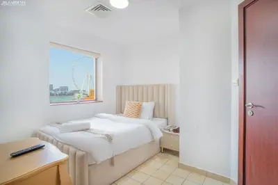 a hotel room with a bed and a window at Gardenia Rimal Suites, Luxury Apartments in JBR with 2 min Walk to JBR beach in Dubai