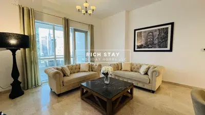 a living room with two couches and a coffee table at Canal View 2BR & Maid Room in KG Tower, Dubai Marina in Dubai