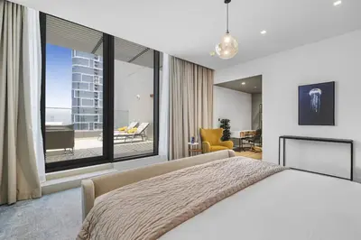 a bedroom with a large bed and a large window at EDEN'S Homes & Villas - 52-42 Emaar in Dubai