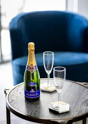 a bottle of champagne and two glasses on a table at EDEN'S Homes & Villas - 52-42 Emaar in Dubai