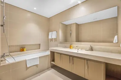 a bathroom with two sinks and a large mirror at EDEN'S Homes & Villas - 52-42 Emaar in Dubai