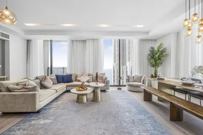 a living room with a couch and a table at EDEN'S Homes & Villas - 52-42 Emaar in Dubai