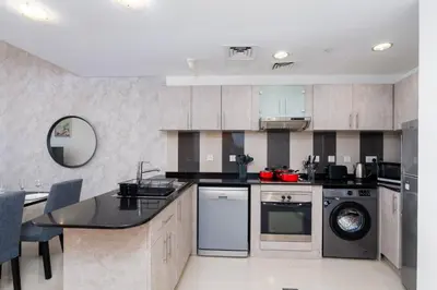 a kitchen with a sink and a dishwasher at White Sage - Incredible Full Sea and Dubai Eye View in Marina in Dubai