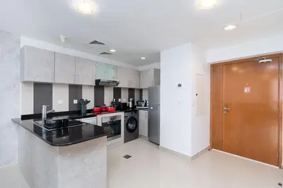 a kitchen with a black counter top in a room at White Sage - Incredible Full Sea and Dubai Eye View in Marina in Dubai