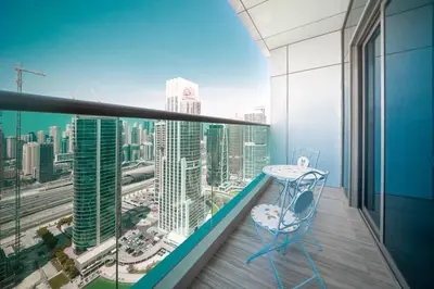 a balcony with a table and a view of a city at Tranquil Retreat with Canal View 1BR MBL Residence - 29AB12 in Dubai