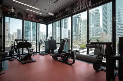 a gym with a view of a city skyline at Tranquil Retreat with Canal View 1BR MBL Residence - 29AB12 in Dubai