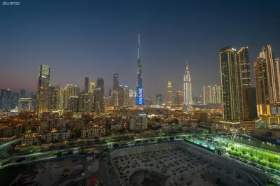 a view of a large city at night at Downtown Damac Distinction Full Burj View in Dubai