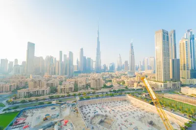 an aerial view of a city with a swimming pool at Downtown Damac Distinction Full Burj View in Dubai