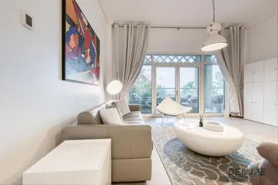 a living room with a couch and a table at Lively 1 BR at Al Nabat Shoreline 8 Palm Jumeirah by Deluxe Holiday Homes in Dubai