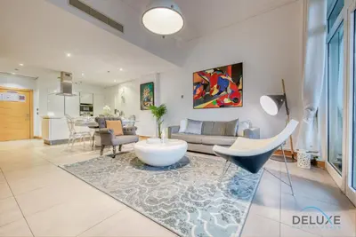 a living room with a couch and a table at Lively 1 BR at Al Nabat Shoreline 8 Palm Jumeirah by Deluxe Holiday Homes in Dubai