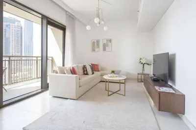 a living room with a couch and a tv at Frank Porter - Creekside18 in Dubai