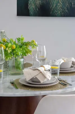 a table with plates and glasses and a napkin at Frank Porter - Creekside18 in Dubai
