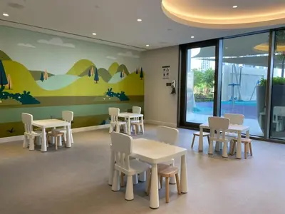 a waiting room with tables and white chairs at Frank Porter - Creekside18 in Dubai