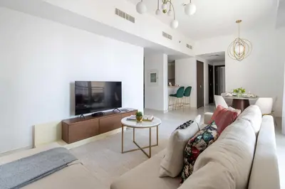 a living room with a couch and a tv at Frank Porter - Creekside18 in Dubai