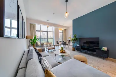 a living room with a couch and a fireplace at EDEN'S Homes & Villas - Atria Residences in Dubai