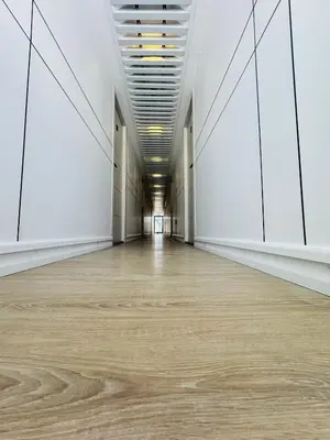 an empty room with white walls and a wooden floor at Boat Camping in Dubai
