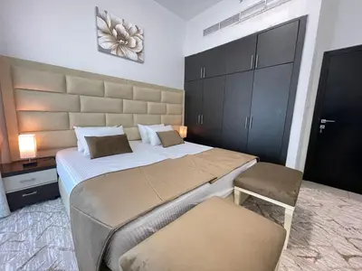 a bedroom with a large bed and two chairs at Private gorgeous Room with Marina view with Shared Kitchen in Shared Apartment in Dubai