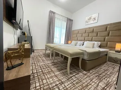 a bedroom with two beds and a television in it at Private gorgeous Room with Marina view with Shared Kitchen in Shared Apartment in Dubai