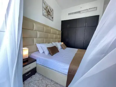 a bedroom with a bed with a black headboard at Private gorgeous Room with Marina view with Shared Kitchen in Shared Apartment in Dubai