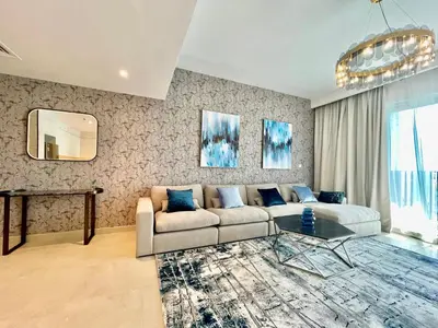 a living room with a couch and a table at Ultimate Luxury at Dubai Creek Horizon Waterfront in Dubai