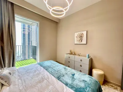 a bedroom with a bed and a large window at Ultimate Luxury at Dubai Creek Horizon Waterfront in Dubai