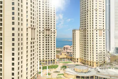 a view of tall white buildings in a city at LUX Contemporary Suite with Marina View 3 in Dubai