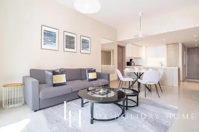 a living room with a couch and a table at LUX Contemporary Suite with Marina View 3 in Dubai