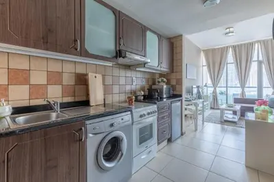 a kitchen with a sink and a washing machine at Frank Porter - Indigo Tower in Dubai