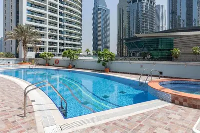 a swimming pool on the roof of a building with tall buildings at Frank Porter - Indigo Tower in Dubai